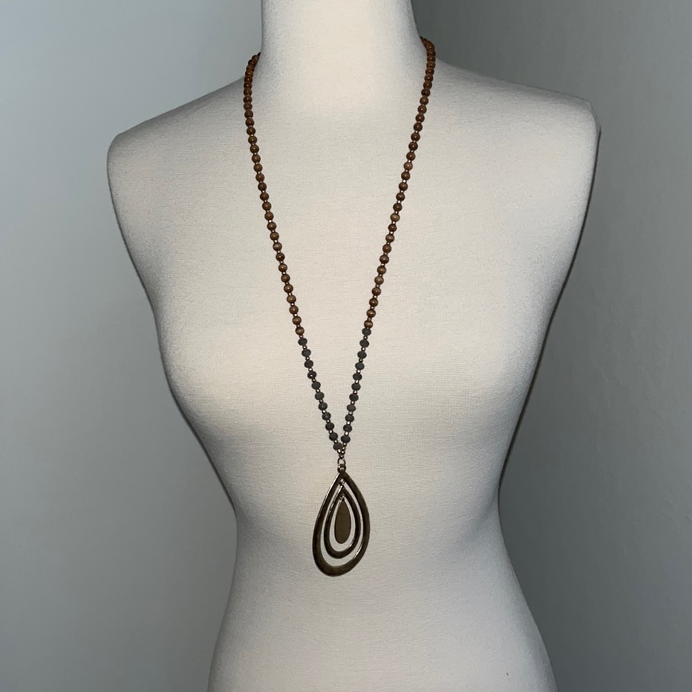 18 “ beaded necklace with gold metal jewel piece.